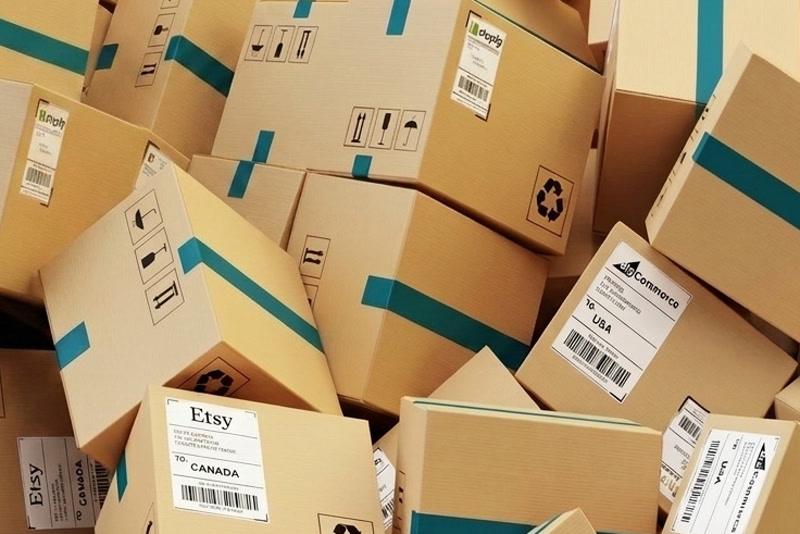 A pile of shipping boxes labelled for several channels and countries